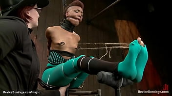 Small tits ebony lesbian slave Nikki Darling in green tights gets nipples tied to toes and caned then in full legs split suspension ass toyed by lezdom Claire Adams on device bondage